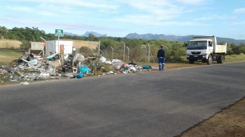 Locked Hawston rubbish dump, with rubbish outside